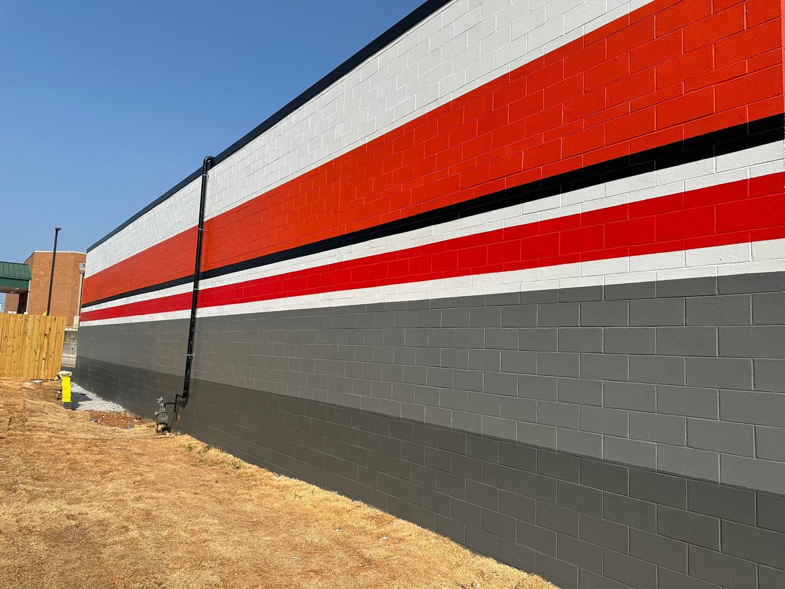 Painted CMU exterior wall with brand stripes